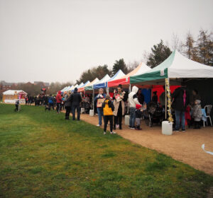 A long row of marquees with crowds of people all the way down
