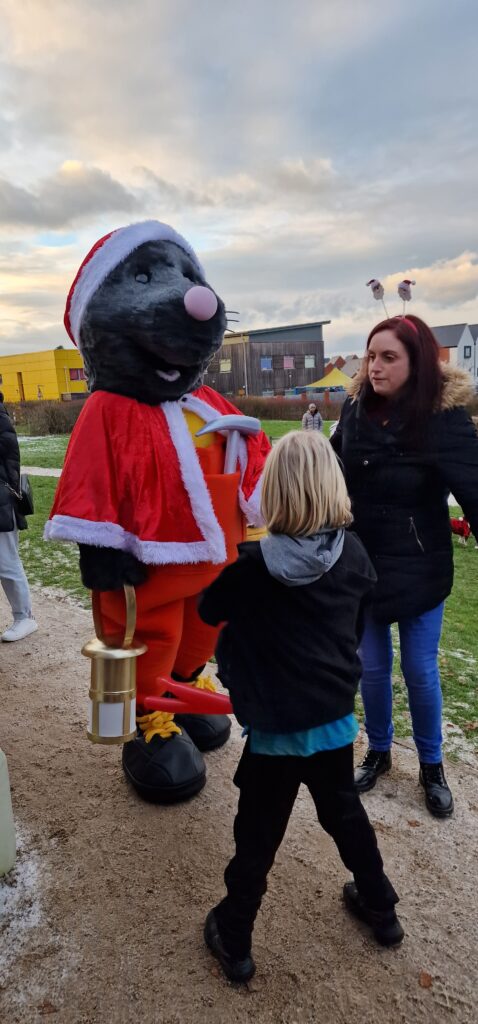 Mawley the mole mascot meets a child