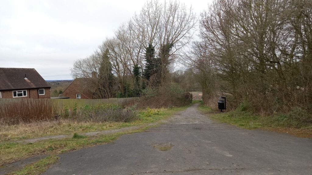 A photograph of a footpath leading off between some trees