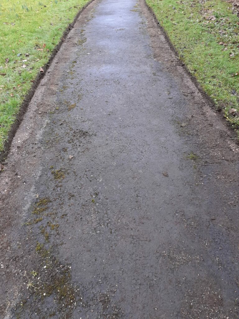 A freshly-cleaned footpath with trimmed edges