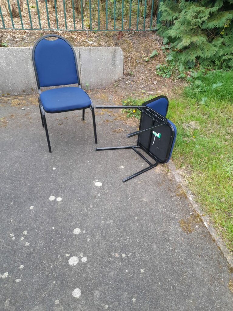 A pair of chairs lying on a tarmac surface