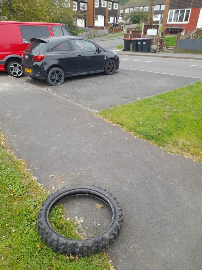 A discarded bike tyre lying on a footpath