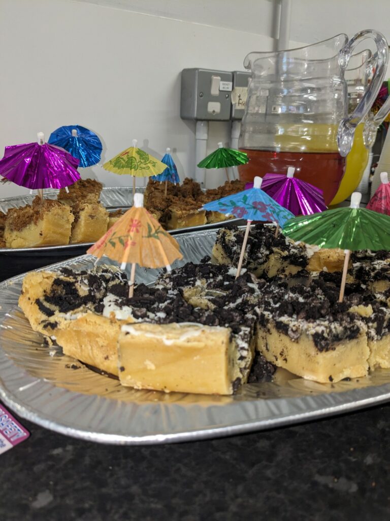 Two platters of cakes with umbrellas sticking out of them