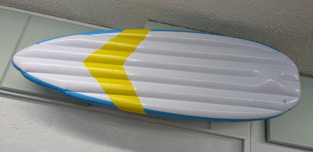 An inflatable surfboard attached to a wall
