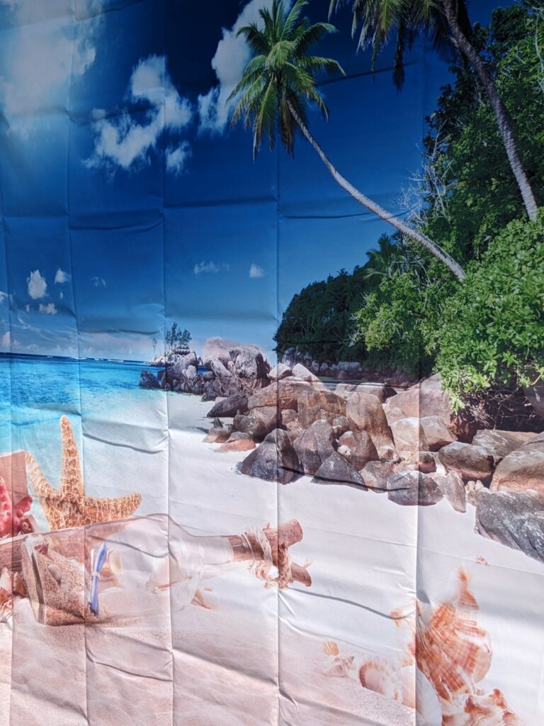 A wall depicting a beach with blue skies and palm trees