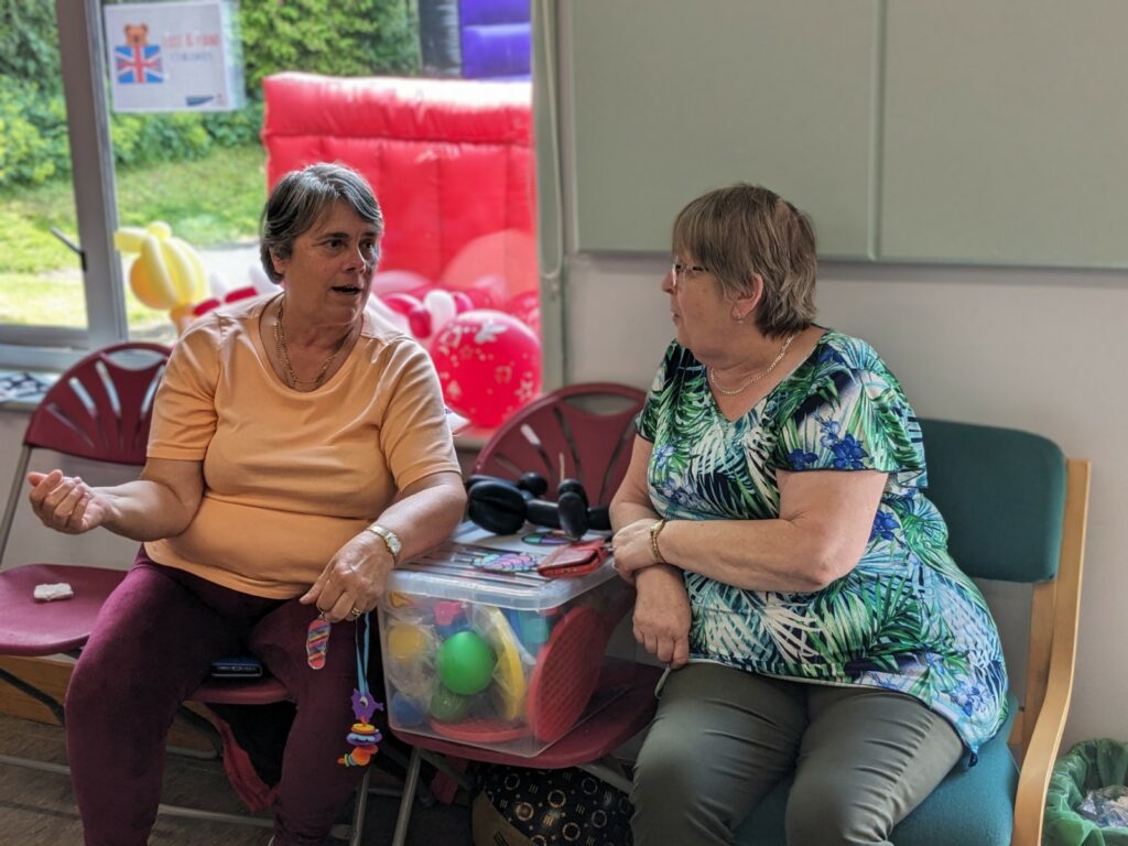 Two people sit talking to each other