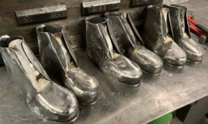 three pairs of steel boots placed in a line